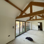 freshly painted room with wooden support beams