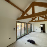 freshly painted room with wooden support beams